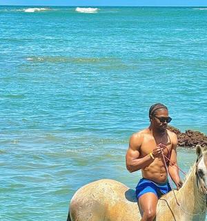 a man riding a horse in the ocean
