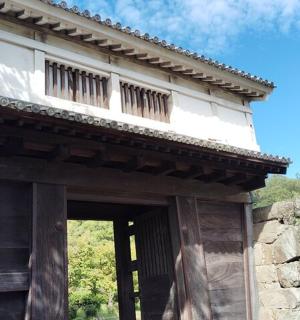 an entrance to a building with a balcony on top