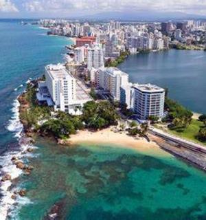 an aerial view of a beach with buildings and the ocean