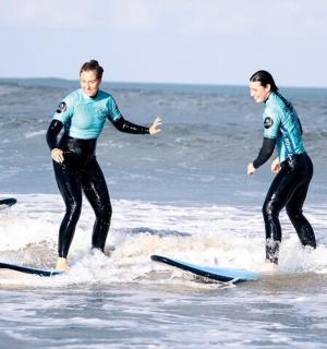two men in wet suits on surfboards in the ocean