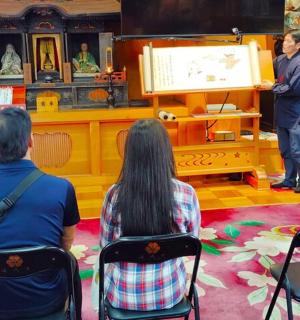 a man and a woman sitting in chairs in front of a television