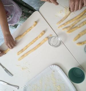 a group of people preparing food on a table