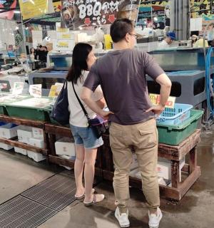 a man and a woman standing in a store