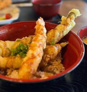 a red bowl filled with fried food with dipping sauce