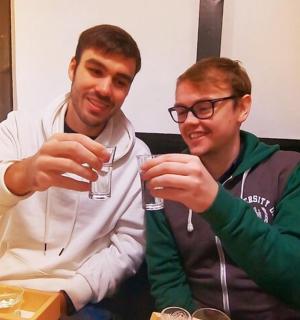 two men holding up wine glasses in front