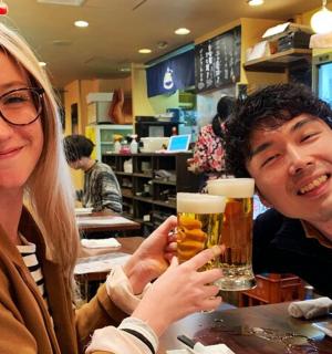 a man and a woman holding glasses of beer