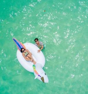 two people on a surfboard in the water