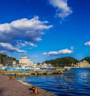 a pier next to a body of water with buildings