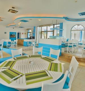 a dining room with a table and white chairs