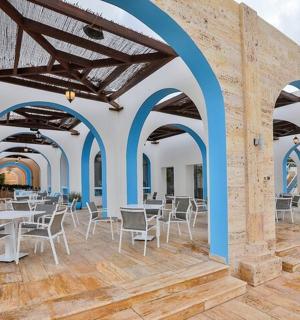a restaurant with blue arches and tables and chairs