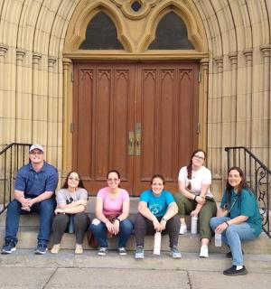 a group of people sitting in front of a building