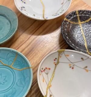 a group of plates sitting on a wooden table