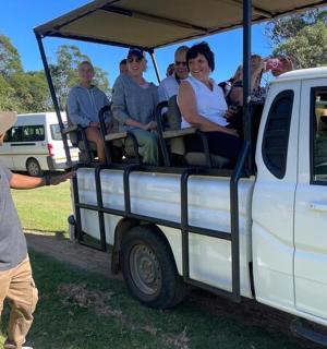 a boy is pointing at a group of people in a truck