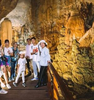 a group of people walking through a cave