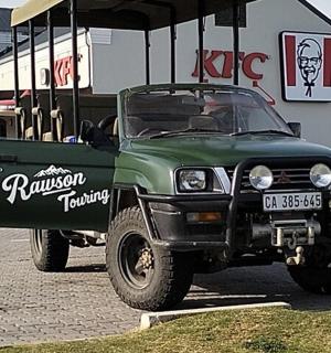 a greenruck is parked in a parking lot