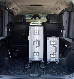 two suitcases sitting in the back of a car