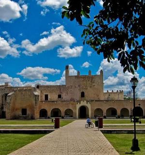 a large castle with a blue sky with clouds