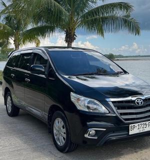 a black van parked on a road next to a body of water