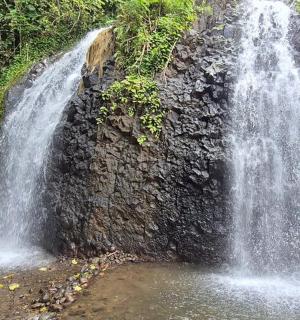 a waterfall on the side of a rock wall