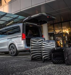 一辆货车旁边放着一堆行李