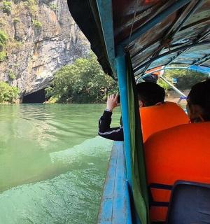a group of people riding on a boat on a river