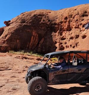 a person driving a jeep in the desert