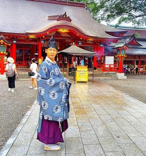 a statue of a person standing in front of a building
