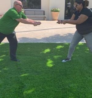 two people playing with a frisbee in the grass