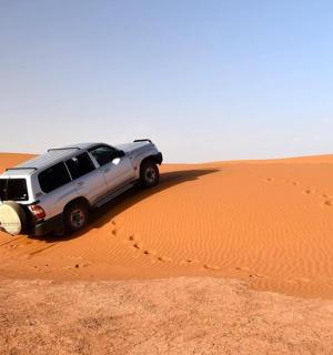 a suv parked in the middle of a desert