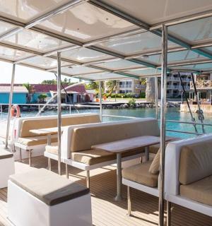 a boat with benches and a pool in the water