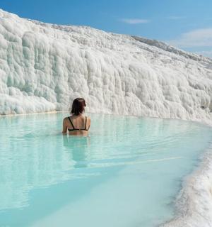 a woman sitting in a pool of blue water