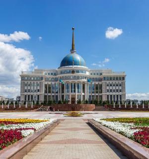 a large building with a dome on top with flowers