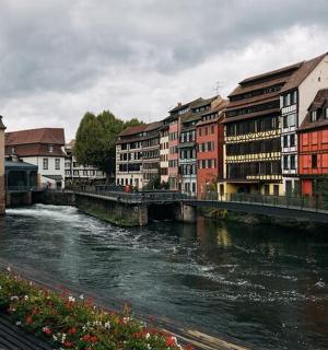 a river in a city with buildings and a bridge