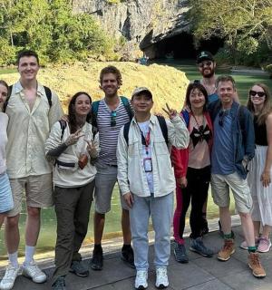 a group of people standing next to a river
