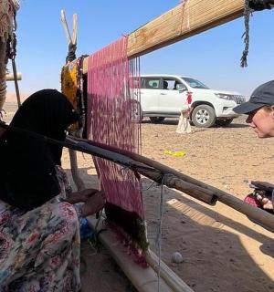 a man and two women sitting on a porch