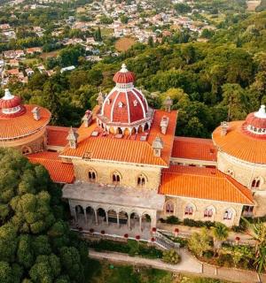 an aerial view of a large building with red roofs