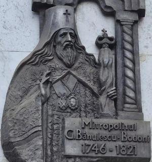 a statue of a god on the side of a building