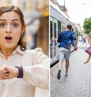a woman pointing at her watch and people walking down a street