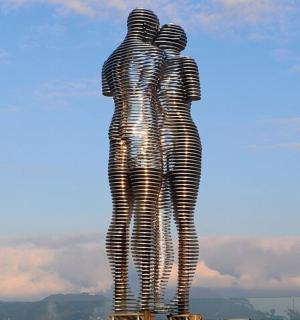 a statue of two people standing next to each other