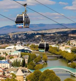 two tarleton gondolas flying over a city