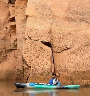 a person sitting on a kayak in the water