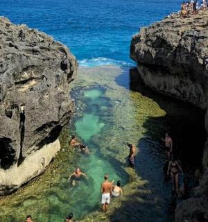 a group of people in the water in a cave