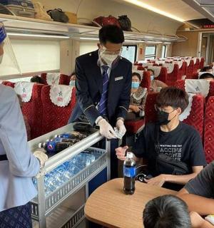 a group of people on a train wearing face masks