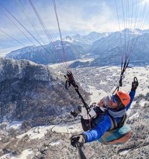 a man is suspended in the air on a parachute