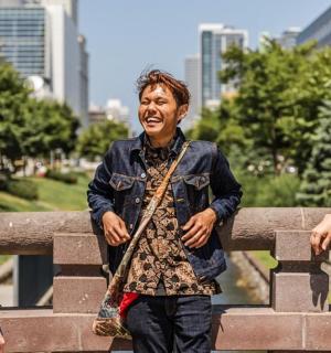 a group of three people standing next to a fence