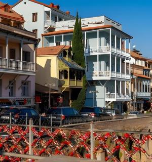 a group of buildings with cars parked in a street