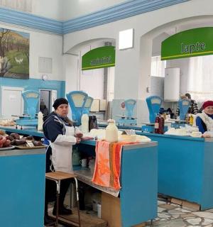 two people in a kitchen preparing food in a kitchen