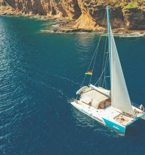 a boat floating in the water near a mountain