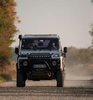 a jeep driving down a dirt road