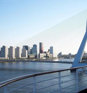 a bridge over a river with a city in the background